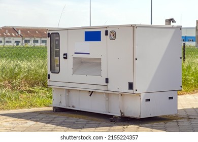 Stand By Electrical Power Generator Behind Industrial Building