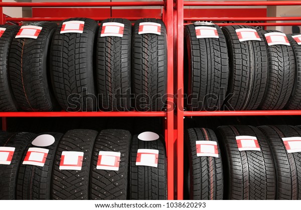 Stand with car tires\
in automobile store