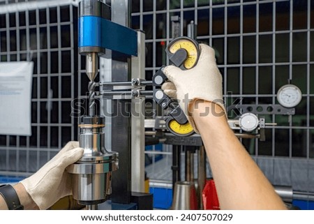 A stand for checking cutters and cutting tools for runout in the centers using indicators.