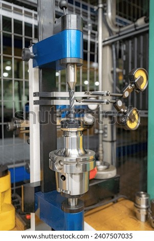 A stand for checking cutters and cutting tools for runout in the centers using indicators.