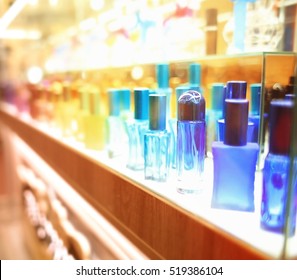 Stand With Colourful Glass Bottles In Cosmetic Store