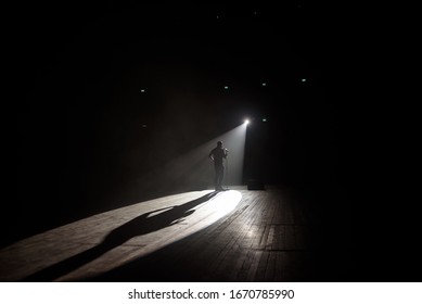 Stand Up Comedian On Stage In The Beam Of Light