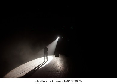 Stand Up Comedian On Stage In The Beam Of Light