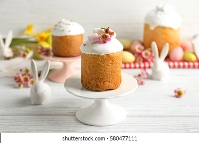 Stand with Easter cake on wooden table
