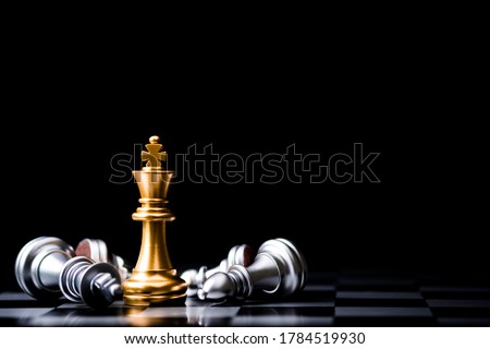 The gold horse, knight chess piece standing with falling silver pawn chess  pieces on chessboard on white background with copy space. Leadership,  winner, competition, and business strategy concept. Photos