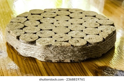 A stand for hot objects made from wine corks. Kitchen items.