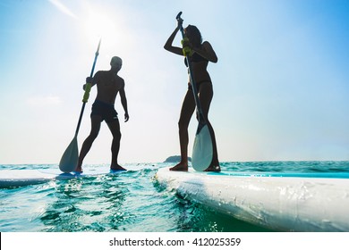 Stand Up Paddle Board Couple Paddleboarding . Young Caucasian Couple On Thailand Beach On Summer Holidays Vacation Travel.