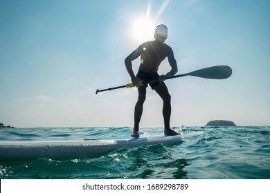 Stand Up Paddle Board Man Paddleboarding . Young Caucasian Male On Thailand Beach On Summer Holidays..