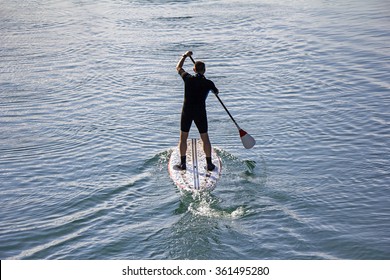 Stand Up Paddle Board Man Paddleboarding On Tranquil Lake