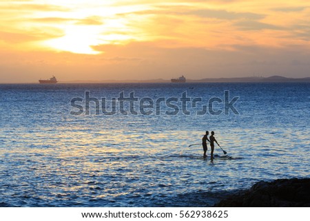 Stand Up Paddling in the Ocean during Sunset 