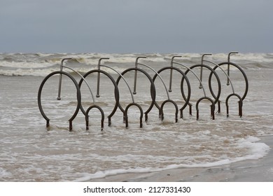 Stand Parking For Bicycles Flooded By The Sea Waves On The Beach In Liepaja. Spring Coastal Flooding. 