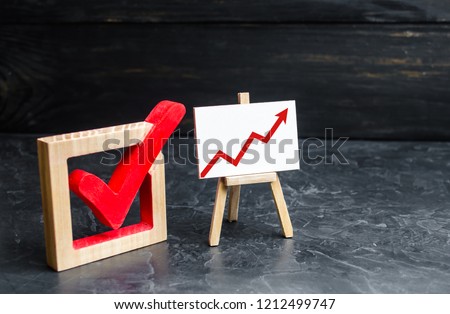Stand with a red up arrow and a check mark. The concept of high voter turnout, the growth of statistical indicators. Voting, high rating. Raising the popularity of politicians parties selective focus