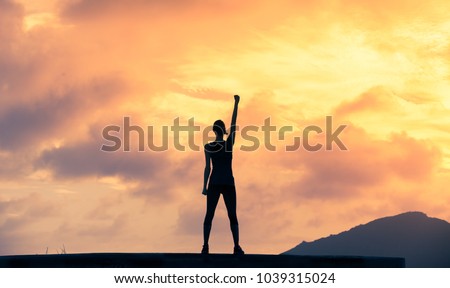 Stand strong. Woman with fist in the air. Feeling motivated, strength and courage concept. 