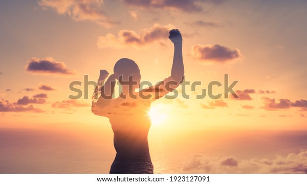 Stand strong. Woman\
flexing her arms in the air. Feeling motivated, strength and\
courage concept. 