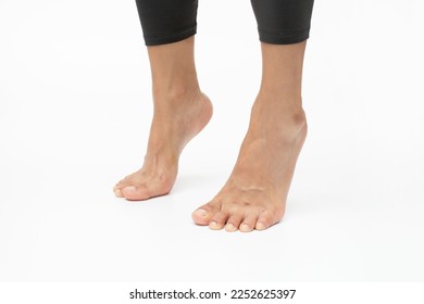 Stand tall on tip-toes. Foot exercises for flexibility and mobility - Shutterstock ID 2252625397