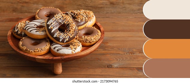 Stand with tasty donuts on wooden table. Different color patterns - Powered by Shutterstock