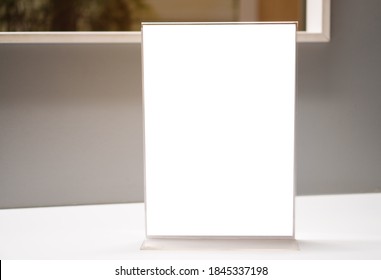 Stand White Mockup Acrylic Frame Tent Card On Counter Reception In Seminar Check In For Register, Background Layout Insert Space For Text Of Information