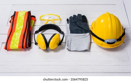 Standard construction safety equipment on white wooden background. safety first concepts - Shutterstock ID 1064795825