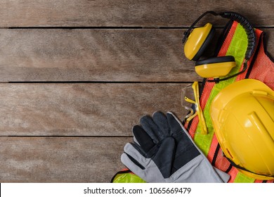 Standard construction safety equipment on old wooden background. top view, safety first concepts - Shutterstock ID 1065669479