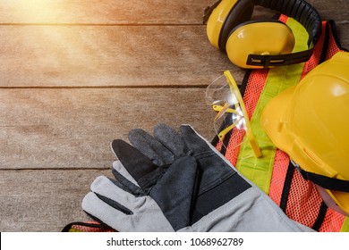 Standard construction safety equipment on old wooden background. top view, safety first concepts - Shutterstock ID 1068962789
