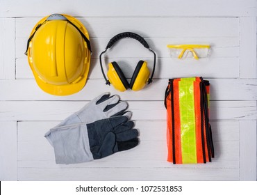Standard construction safety equipment on white wooden background. top view, safety first concepts - Shutterstock ID 1072531853