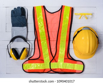 Standard construction safety equipment on white wooden background. top view, safety first concepts - Shutterstock ID 1090401017