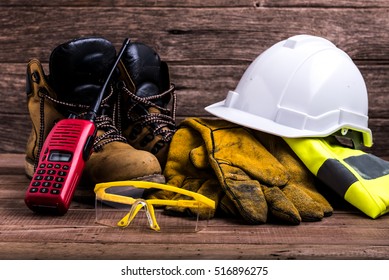 Standard Construction Safety Equipment On Wood Background