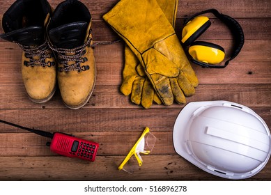 Standard Construction Safety Equipment On Wood Background