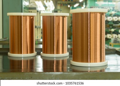 Standard Copper Wire Enamel In A Bobbin On The Table, Steel Floor In The Factory. The Backdrop Is A Machine. Winding Machine