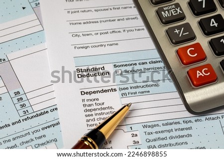 Standard deduction on federal income tax return forms and calculator. Federal tax return, income tax and tax refund concept