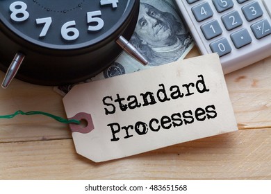 Standard Processes Word on tag with clock,dollar note and calculator,Finance Concept - Shutterstock ID 483651568