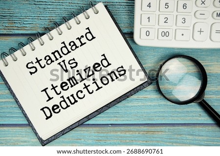 Standard Vs Itemized Deductions text on notepad with magnifying glass and calculator on wooden background