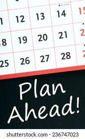 A Standard Wall Calendar On A Blackboard With The Phrase Plan Ahead! Written Beneath It