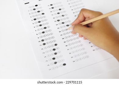 Standardized Test Form With Answers Bubbled In And A Pencil, Focus On Anser Sheet