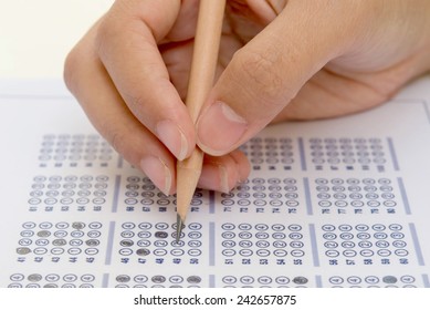 Standardized Test Form With Answers Bubbled In And A Pencil, Focus On Anser Sheet