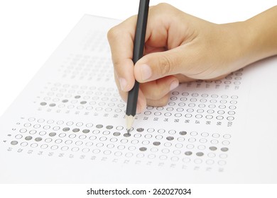 Standardized test form with answers bubbled in and a pencil, focus on anser sheet - Shutterstock ID 262027034