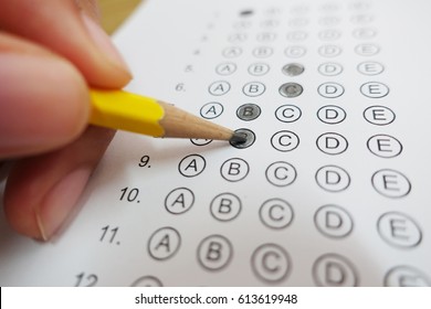 Standardized Test Form With Answers Bubbled In And A Pencil, Focus On Anser Sheet