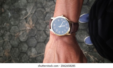 Standing Asian Young Man Wearing A Watch