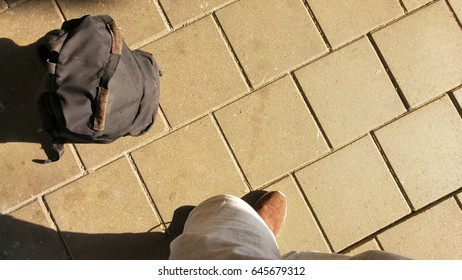 standing beside a backpack