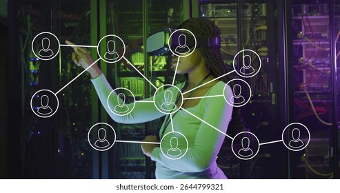 Standing Black woman touching floating network-connection overlay in server room, with VR headset. Futuristic, technology, cybersecurity, innovation, digital, immersive, professional