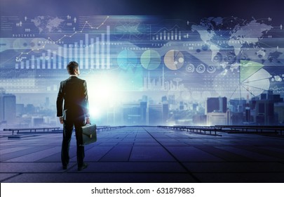 Standing Businessman Who Looks Various Graphics Of Business. Internet Of Things. Information Communication Technology. Digital Transformation. Abstract Mixed Media.