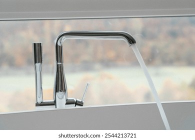 a standing faucet with a high flowing water pressure in a white freestanding bathtub   - Powered by Shutterstock