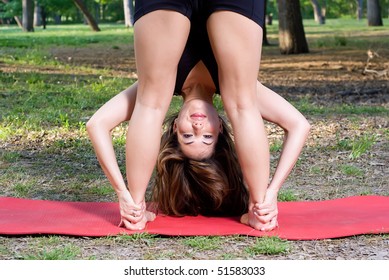 Standing Forward Fold Yoga Pose In The Park