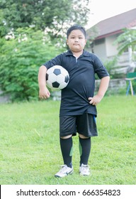 Standing Obese Fat Boy  Soccer Player With Football On Green Grass Background, Healthy Concept