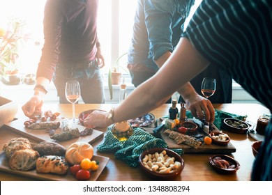 Standing People Picking Up Tapas Food Form A Table. Friends And Family  Togetherness Concept.