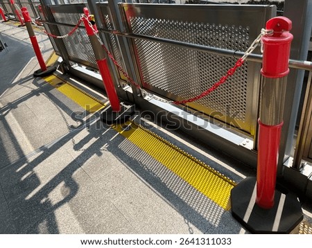 Standing plastic post and chains barrier for area management.