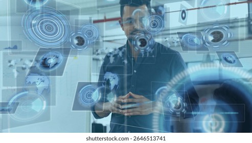 Standing South Asian man interacting with holographic UI in tech lab, with data overlay. Futuristic, technology, data, interface, innovation, digital, professional