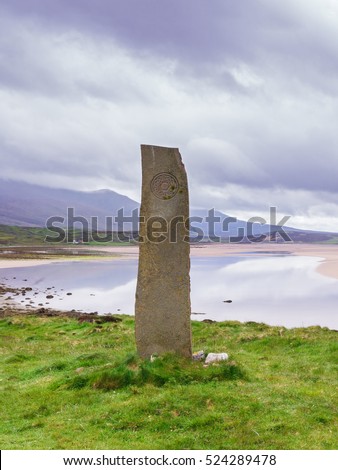 Standing stone with ancient Keltic symbols by the Kyle of Durness at Keoldale, near Durness, Sutherland, Scotland, UK