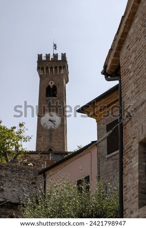 Standing tall amidst historic brick buildings, Santarcangelo's ancient clocktower whispers tales of bygone eras.