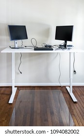 Standing White Desk In Home Office With Minimal Minimalism Design, Two Computer Screens, Laptop, Wires, Mat Protector For Healthy Active Work Space